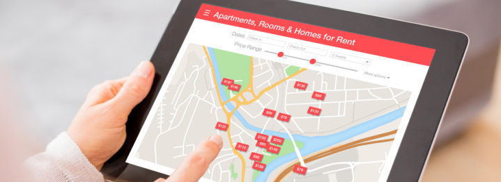 Person looking for places to stay on digital tablet app