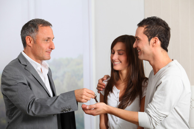 katy realtor handing keys to tenant moving into home