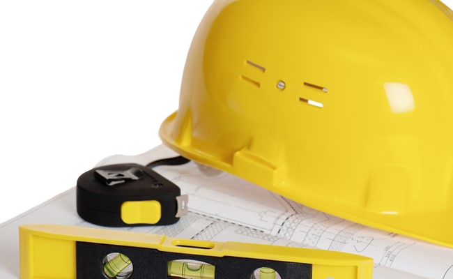 hard hat and architectural drawings