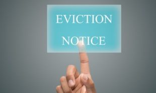 Houston property manager giving a residential tenant an eviction notice