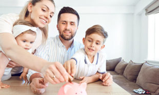 A smiling family saves money with a piggy bank
