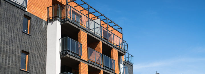 Modern, luxury apartment building with glass balconies.