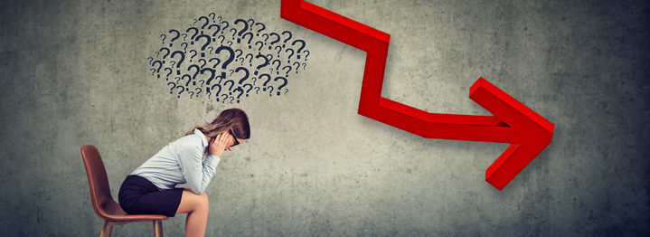 Depressed businesswoman looking down at the falling arrow feeling confused has many questions