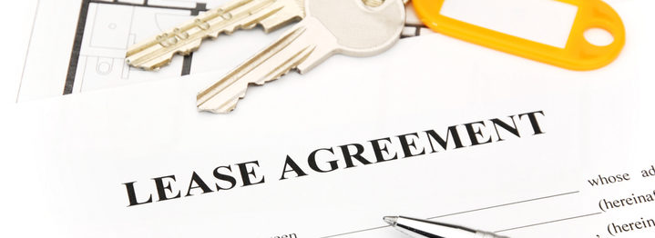 Keys and pen on lease agreement document