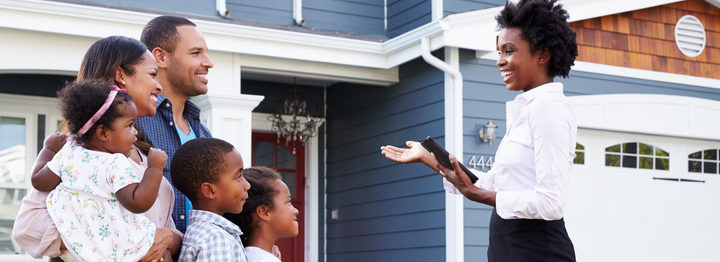 Real estate agent showing a family a house, closer in