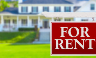 For Rent Real Estate Sign in Front of House