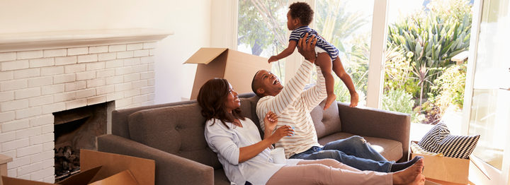 Parents Take A Break On Sofa With Son On Moving Day