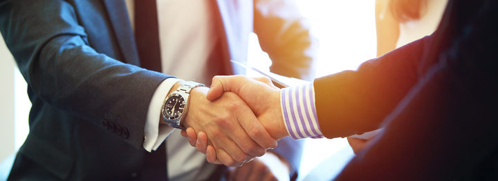 Business people shaking hands, finishing up a meeting.