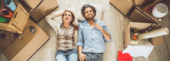 Young couple moving in into new apartment