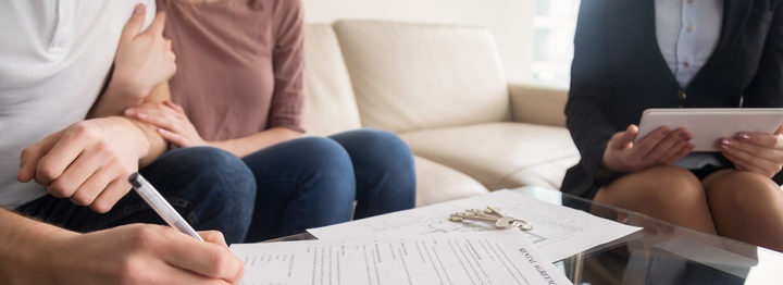 Signing of rental agreement, couple meeting with real estate agent
