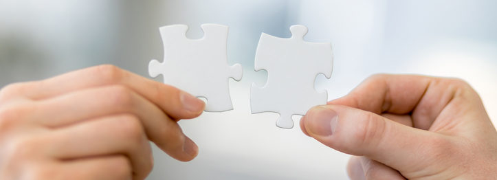 man and woman hand holding jigsaw puzzles, business matching concept
