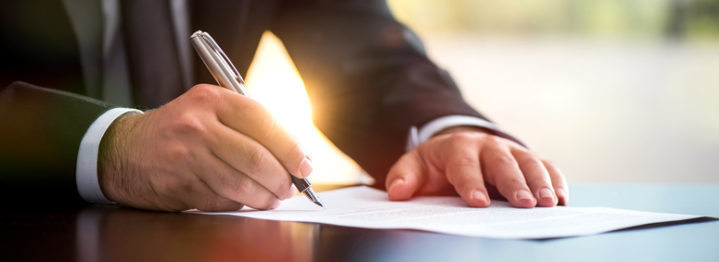 Businessman Is Signing A Legal Document In Office