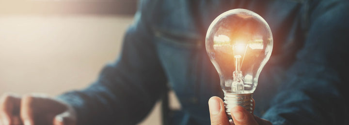 business accountin with saving money with hand holding lightbulb concept financial background
