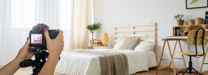 Blogger taking a photo of bedroom