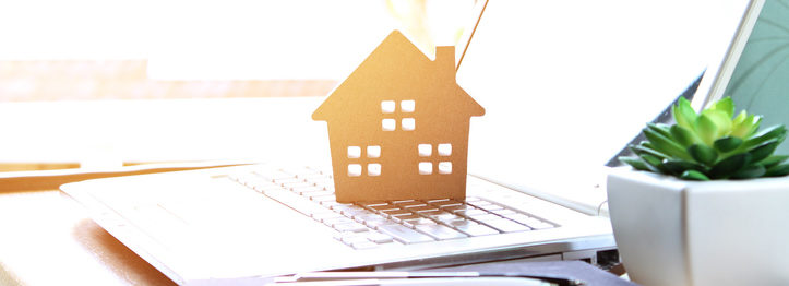 Wood house model on computer laptop