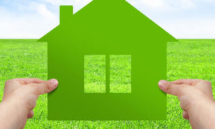 Make your house concept, hands hold green house