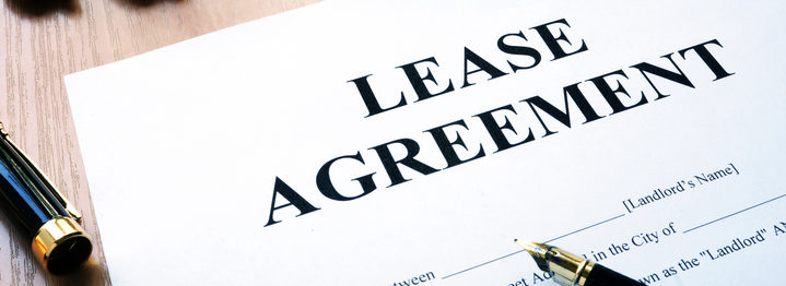 Rental lease agreement form on an office desk.