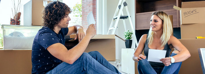 Couple unpacking moving boxes