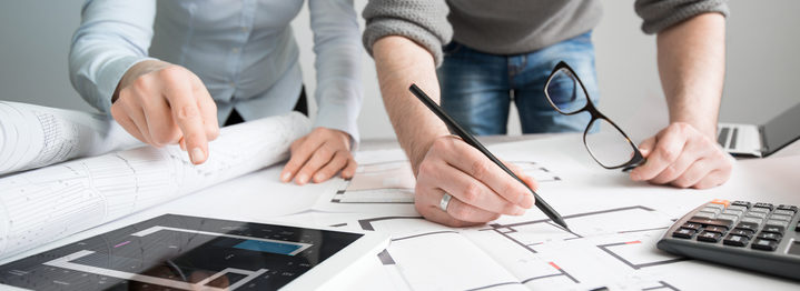 Designers discuss the sketches inside the house.