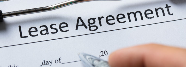 Human Hand Filling Lease Agreement Form