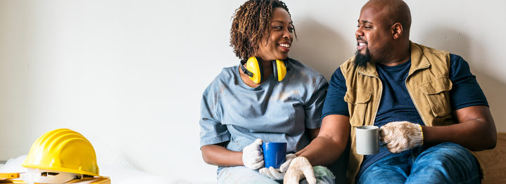 Couple resting after doing home demolition work