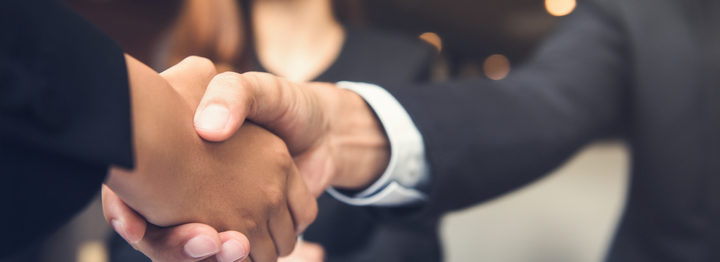 Businessmen shaking hands after meeting in a cafe