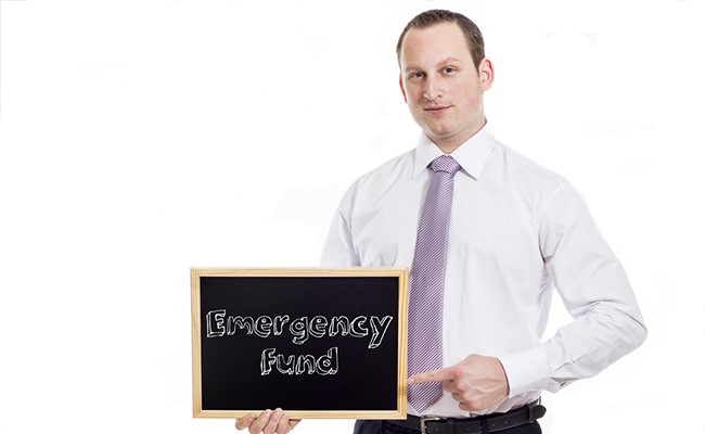 katy man pointing to sign with emergency fund written on it