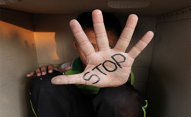 stop written on hand of person in box