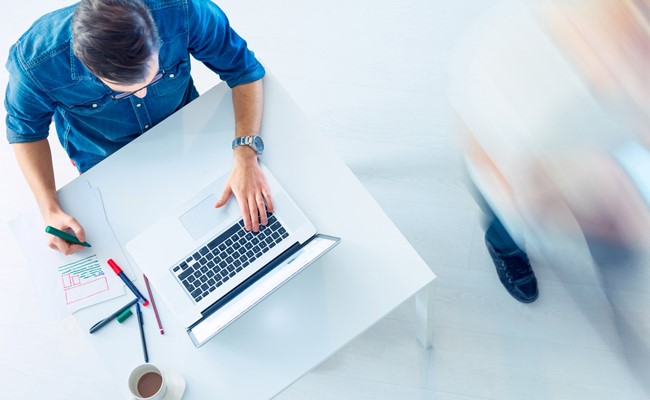 houston realtor on computer and taking notes