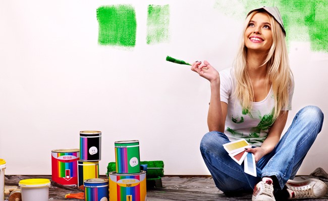 woman painting residential wall